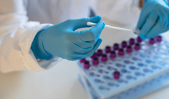 Lab worker holding vials