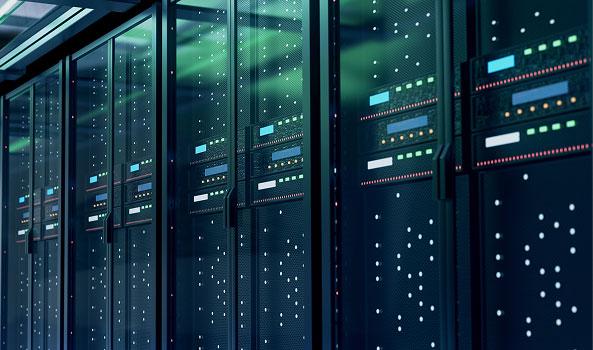 Long row of dark server racks with many glowing green and blue indicator lights.