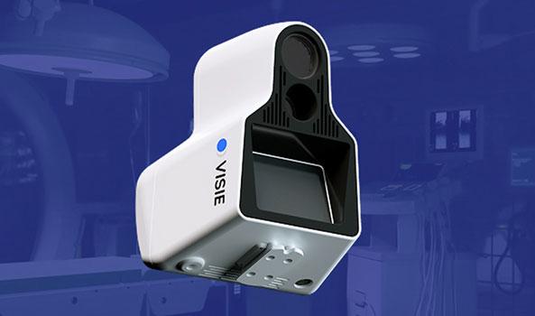 White and black VISIE medical device with a blue indicator light in a surgical room.
