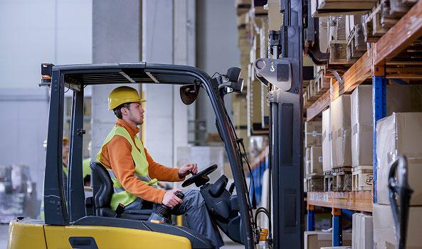 Forklift driver in warehouse
